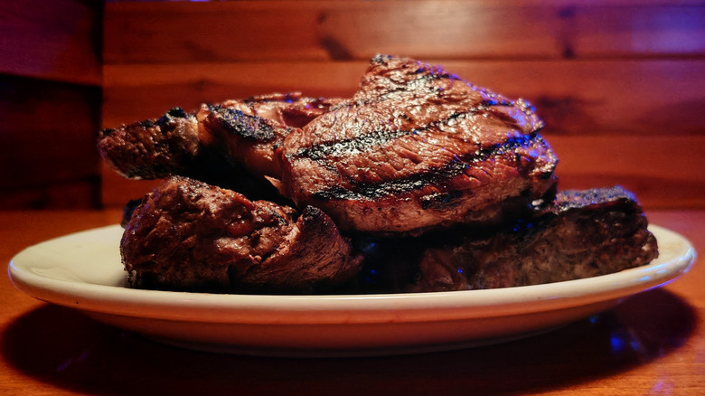 A pile of Texas Roadhouse steaks on a plate