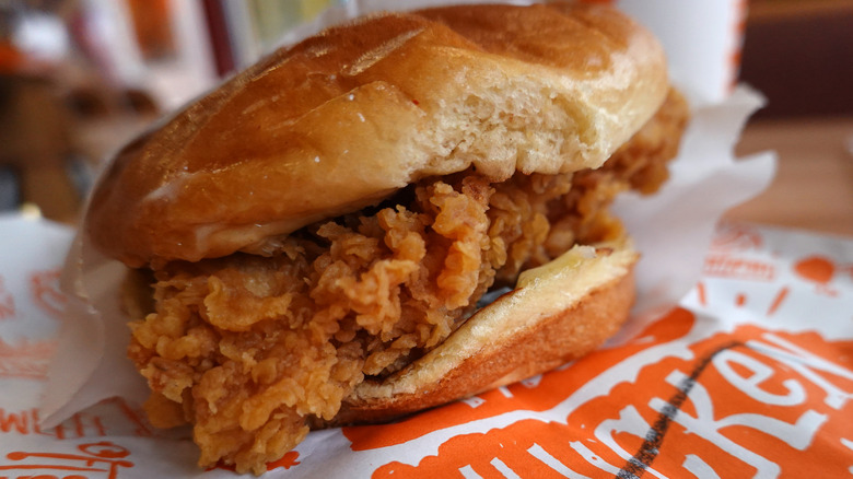 Popeye's chicken sandwich on table