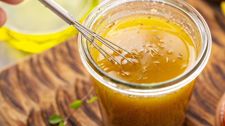 Vinaigrette in a jar with whisk