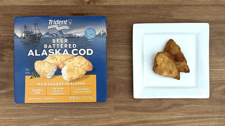 A box of Trident Seafoods beer battered Alaska cod, with the cooked product on a plate