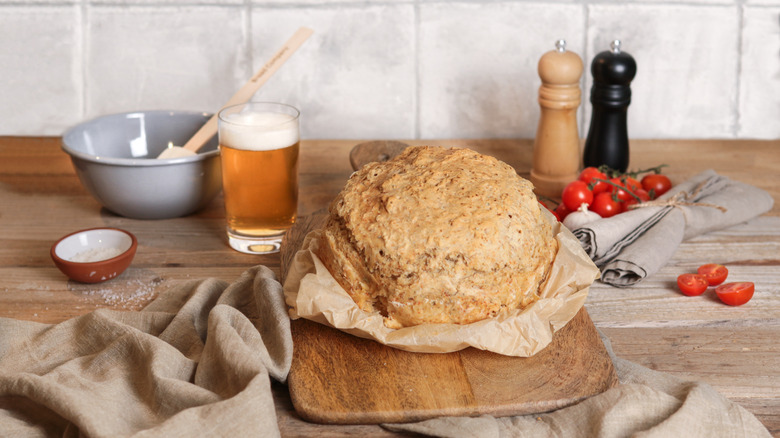 glass of beer next to bread and ingredients