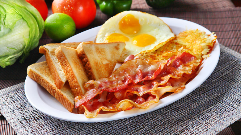 Eggs, toast, bacon, and hash browns