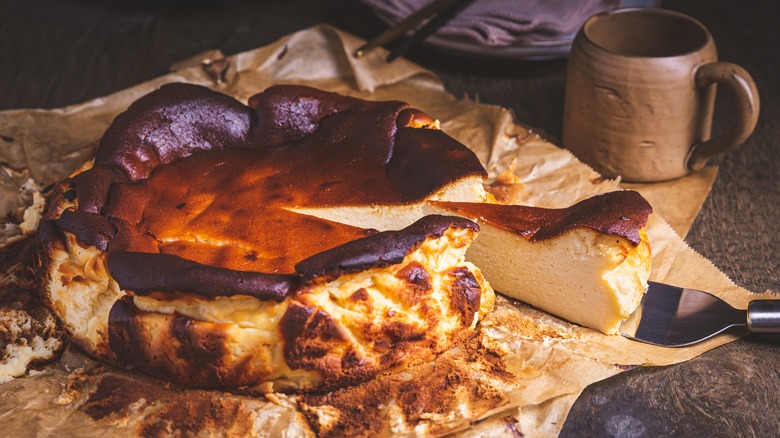 Fresh Basque cheesecake with a slice being pulled out