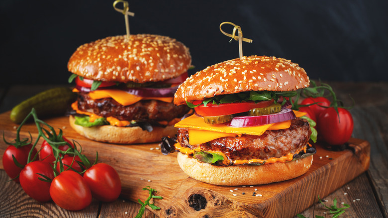 Two hamburgers on a serving board