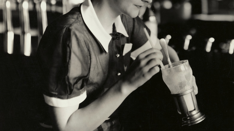 Woman drinks a milkshake