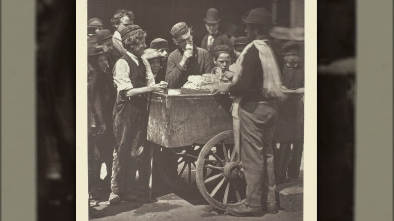 children around street peddler 1881