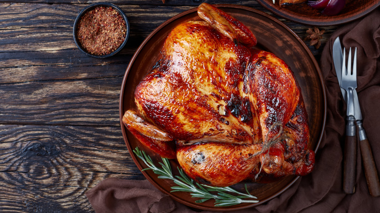 whole roasted chicken on a rustic wood background