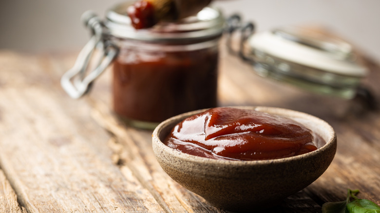 barbecue sauce in bowl on wooden table