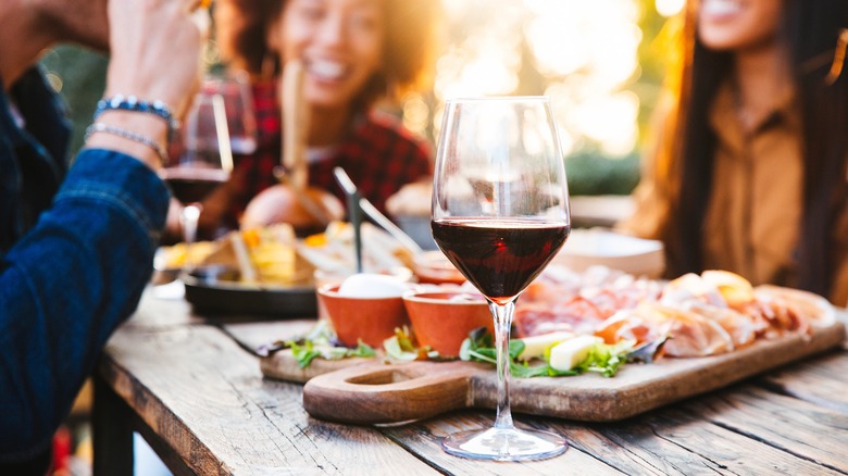 A glass of red wine on a wooden table