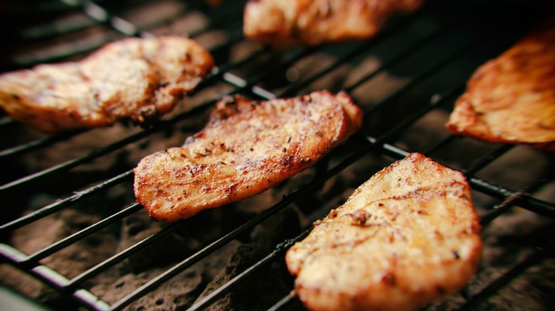 Chicken grilling on lava rocks