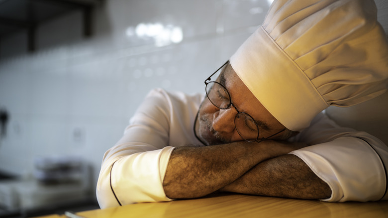 Chef sleeping on a kitchen counter