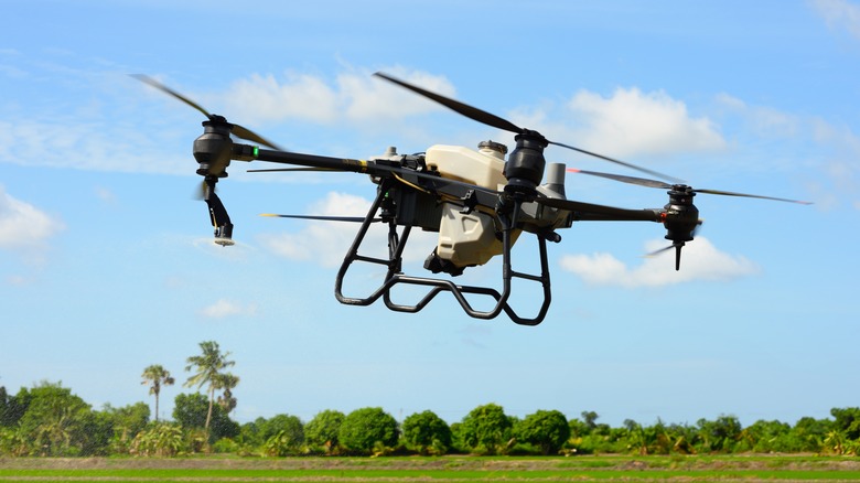A small quadcopter drone flying over a field