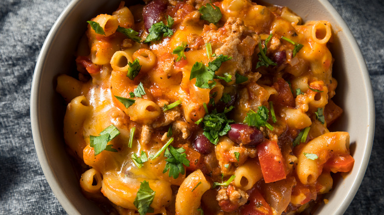 A closeup of a bowl of chili mac and cheese