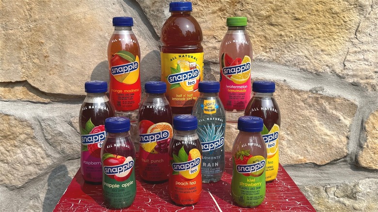 Snapple bottles stacked on red table