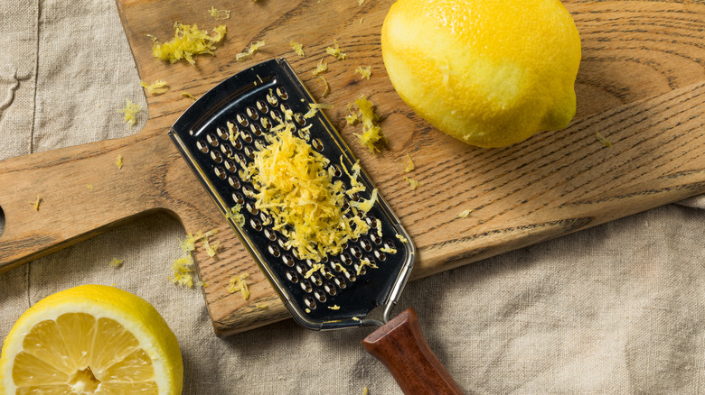 A pile of lemon zest on top of a grater