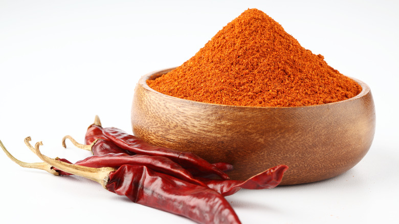 Chile powder in bowl with chiles