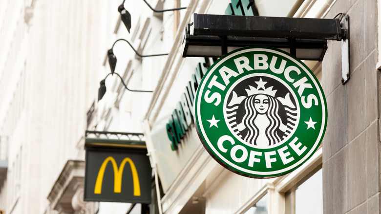 Starbucks sign with McDonald's sign in the background