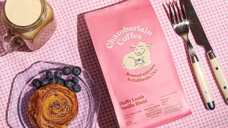 A bag of Chamberlain Coffee Fluffy Lamb Vanilla Blend styled on pink table cloth