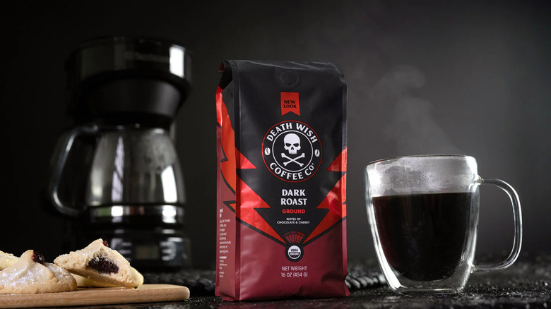 A bag of Death Wish Dark Roast styled with coffee cup and pastry