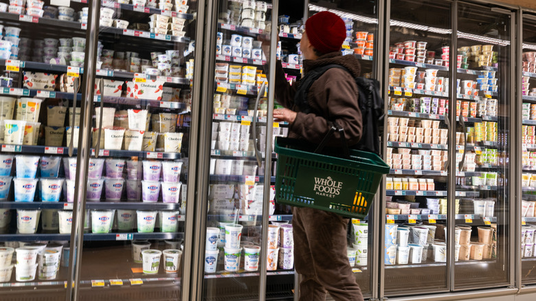 A Whole Foods customer selects yogurt