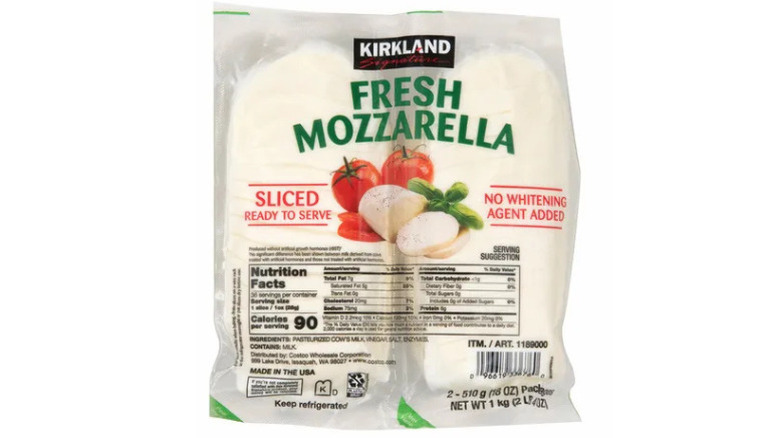 a bag of two balls of fresh fresh mozzarella against a white background.