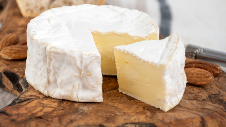 A block of brie cheese on a wooden block