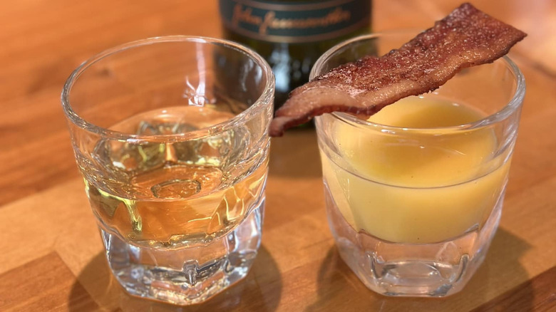 shot glasses of whiskey and oj with bacon