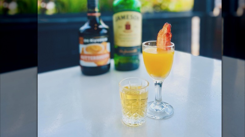 Irish breakfast shot in two shot glasses with bottles in background