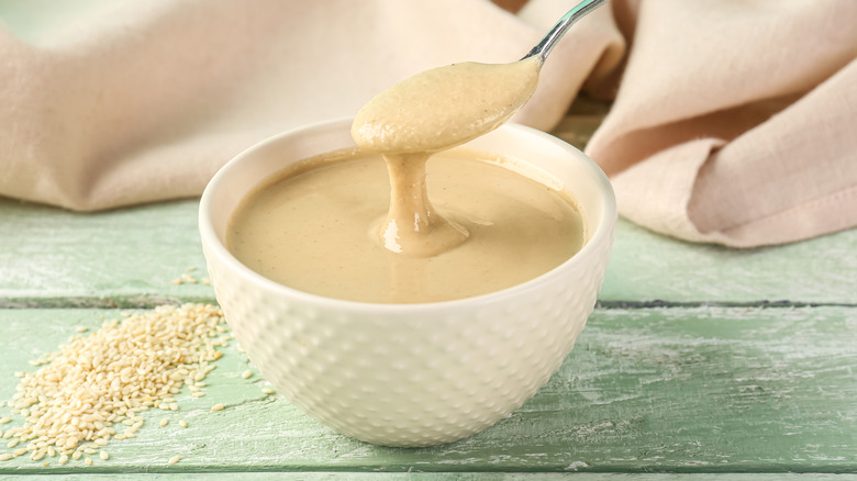 Bowl of tahini with spoon in it