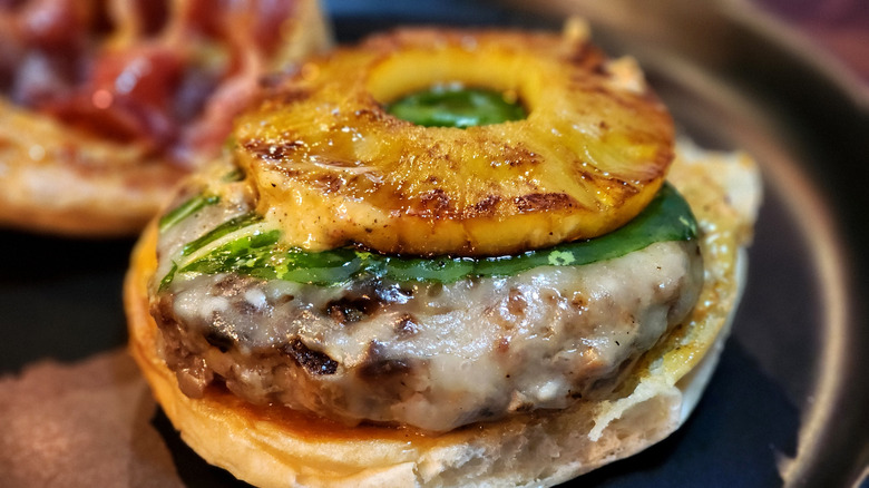 Beef hamburger with a slice of pineapple