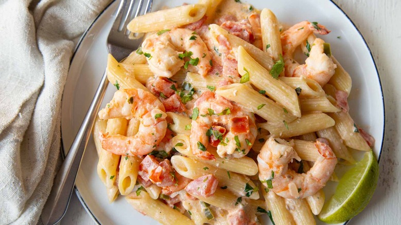creamy pasta with shrimp and pico de gallo on plate