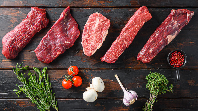 overhead shot of a variety of marbled steak cuts including skirt and hanger steaks