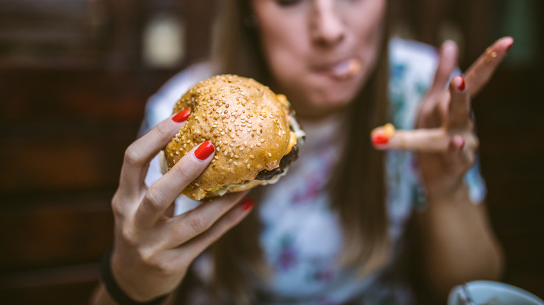 woman eating fast food burger