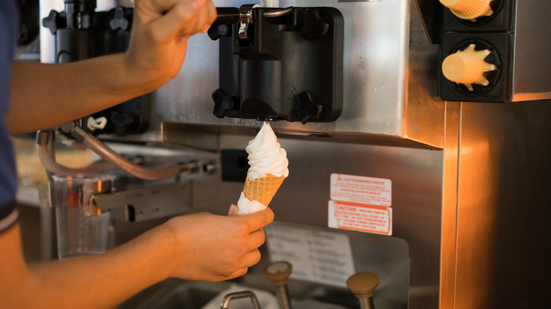 person using ice cream machine