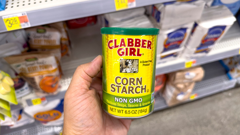 Hand holding container of Clabber Girl Cornstarch