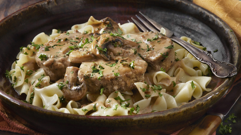 Bowl of beef stroganoff with fresh parsley