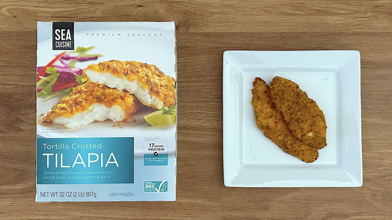 A box of Sea Cuisine Tortilla Crusted Tilapia, next to the cooked product on a plate