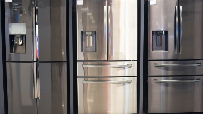 Three reflective refrigerators for sale and on display
