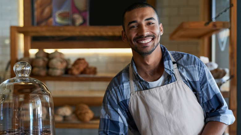 A restaurant server smiling