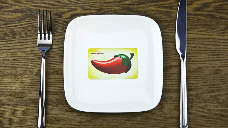Chili's gift card on white plate with flatware