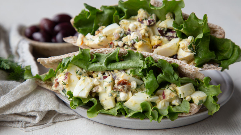 egg salad in pita bread on a white plate