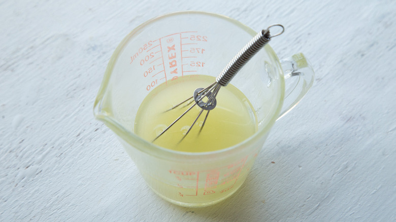 lemon juice in a measuring cup with whisk