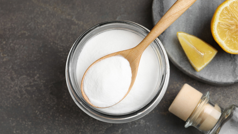 Clear bowl of white powder with a wooden spoon