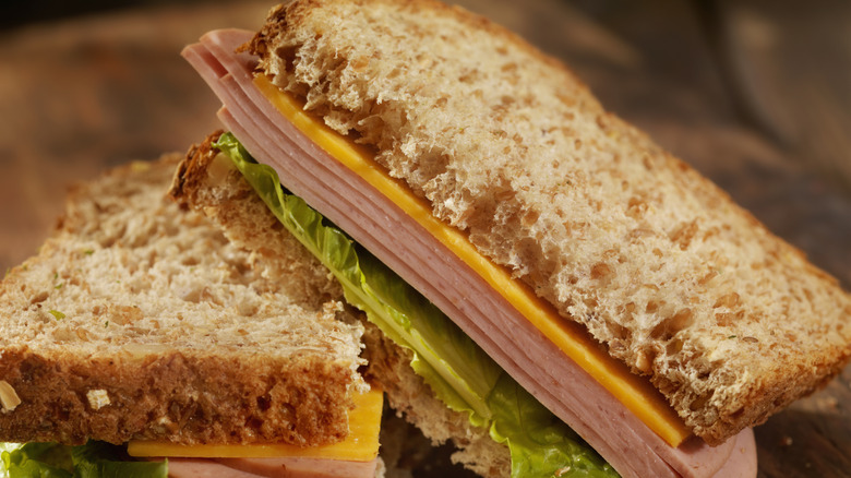Bologna and cheese sandwich on wood board