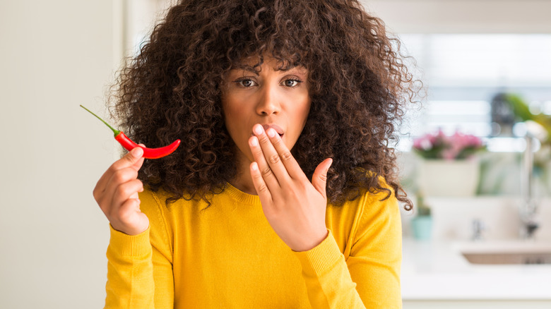 woman holding chili pepper