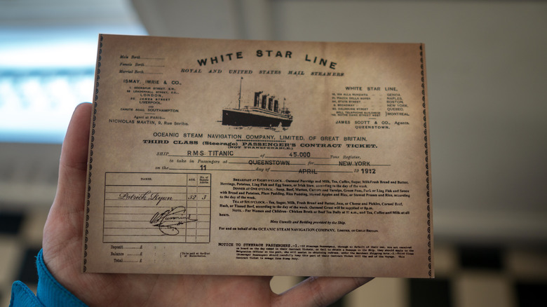 Hand holding Titanic ticket