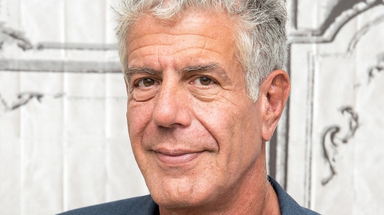 Anthony Bourdain smiling in blue blazer