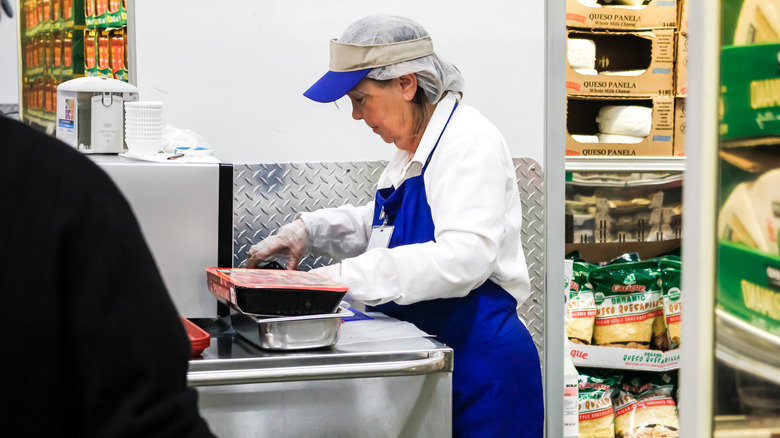 Woman staffing Costco sample station