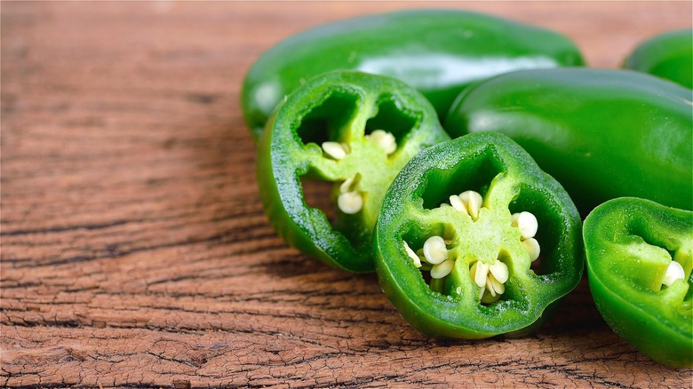 Fresh whole and sliced jalapeños