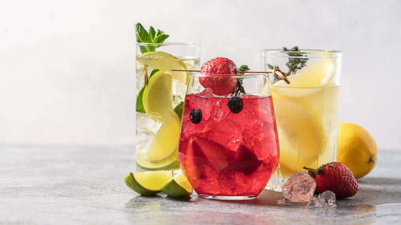 Glasses of colorful drinks with fruits